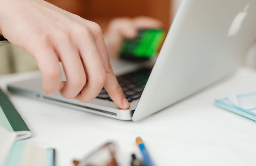 homeowner comparing home warranty plans on a laptop at a kitchen table