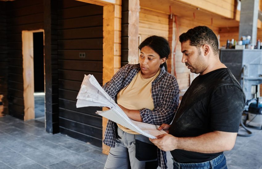 Homeowner and contractor reviewing renovation plans and financing options