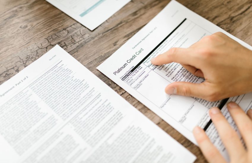 person reading the fine print of a timeshare contract at a table