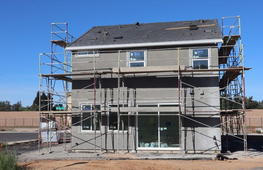 Installer fitting new energy efficient windows on a home before winter